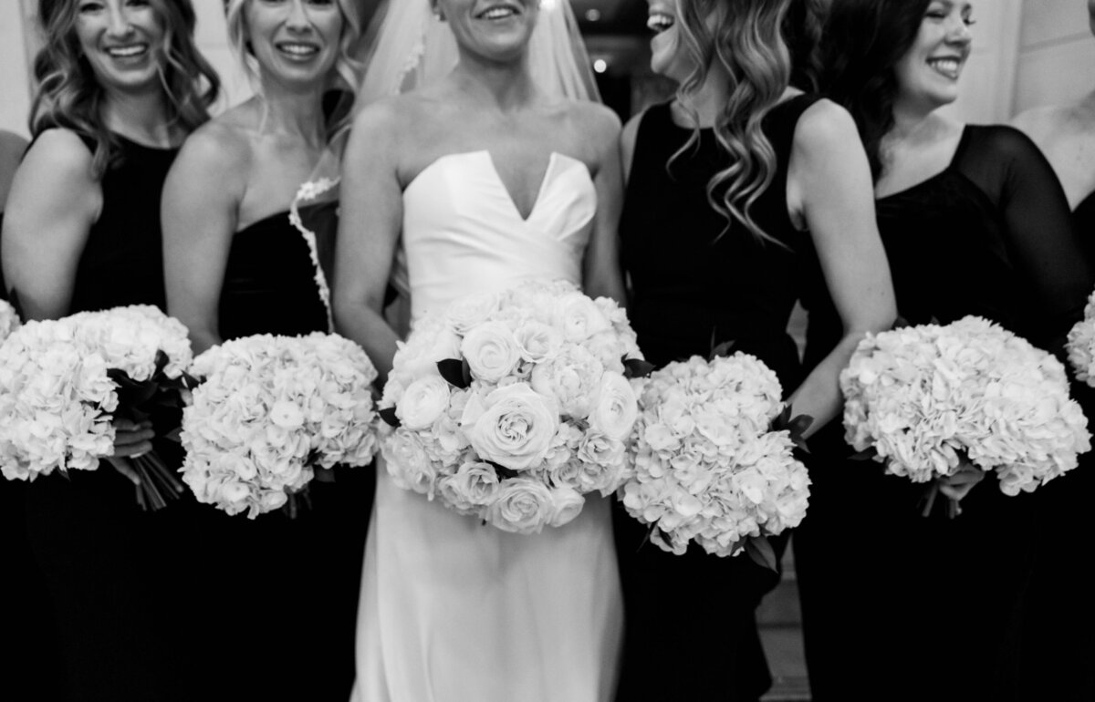 Bride doing a first look with her bridesmaids and their reactions full of smiles and joy