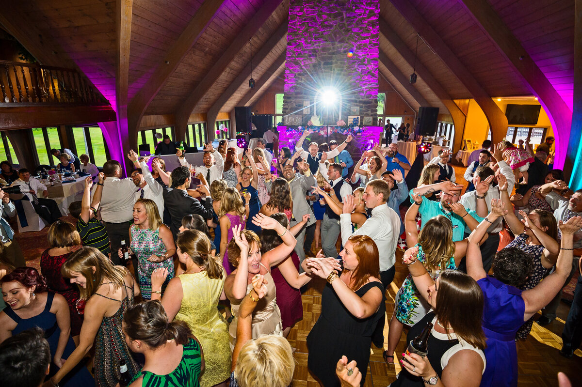 Wedding crowd dancing to DJ music during reception at Peek'n Peak Resort.