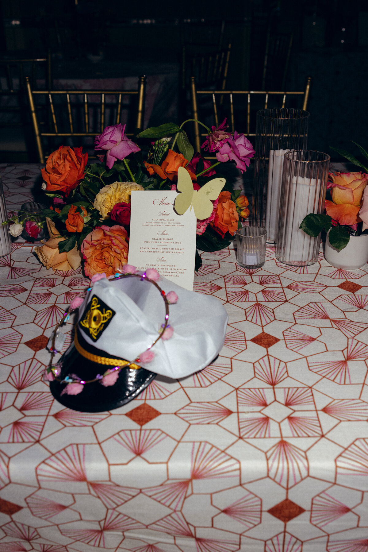 A wedding photo of a sailors hat left on a table during the wedding reception