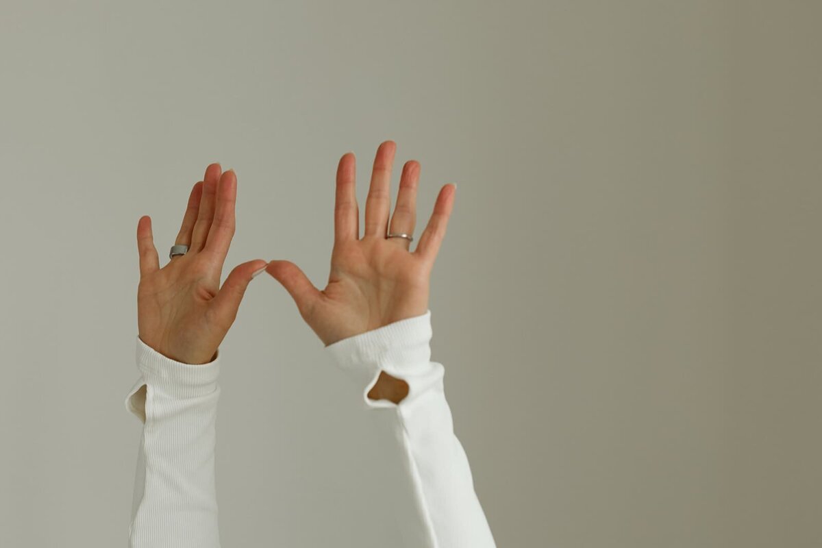 Close-up of open hands in a Kundalini mudra gesture, symbolizing energy flow and presence