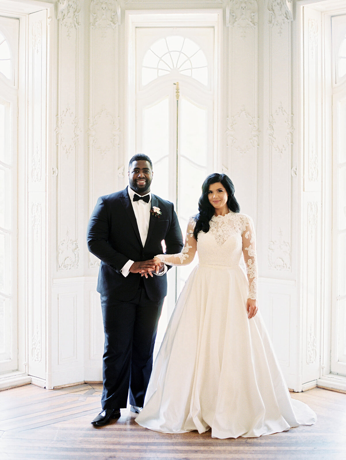 interracial bride and groom holding hands at cylburn arboretum mansion in baltimore