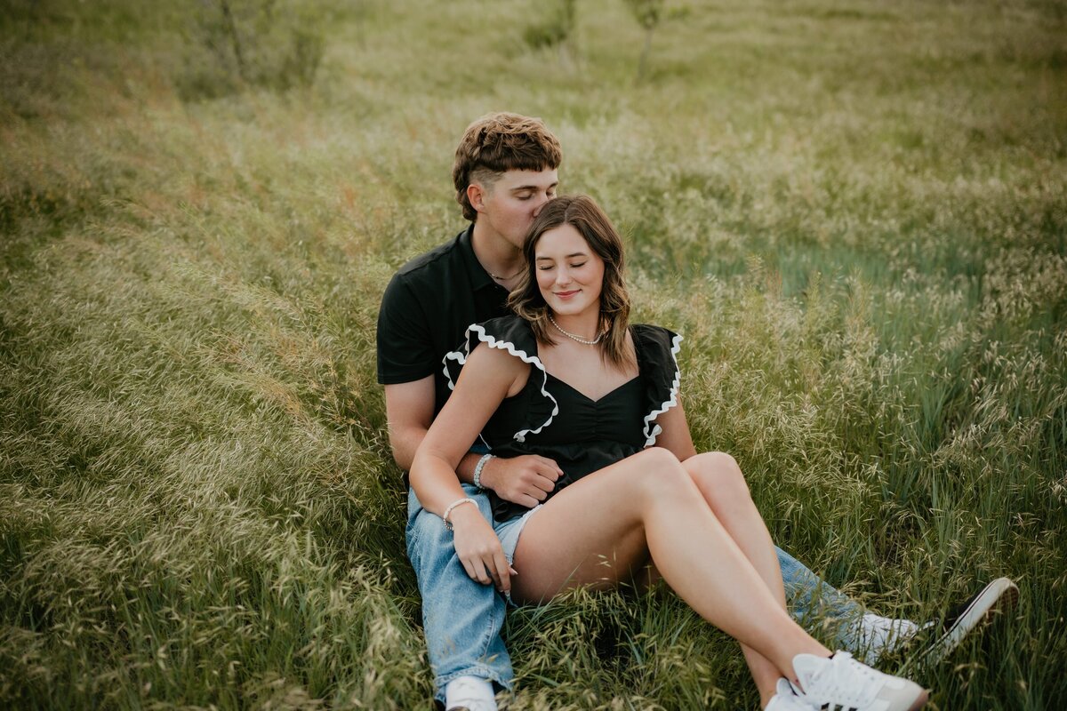 couples portrait session, couple sitting in grass field in amarillo texas