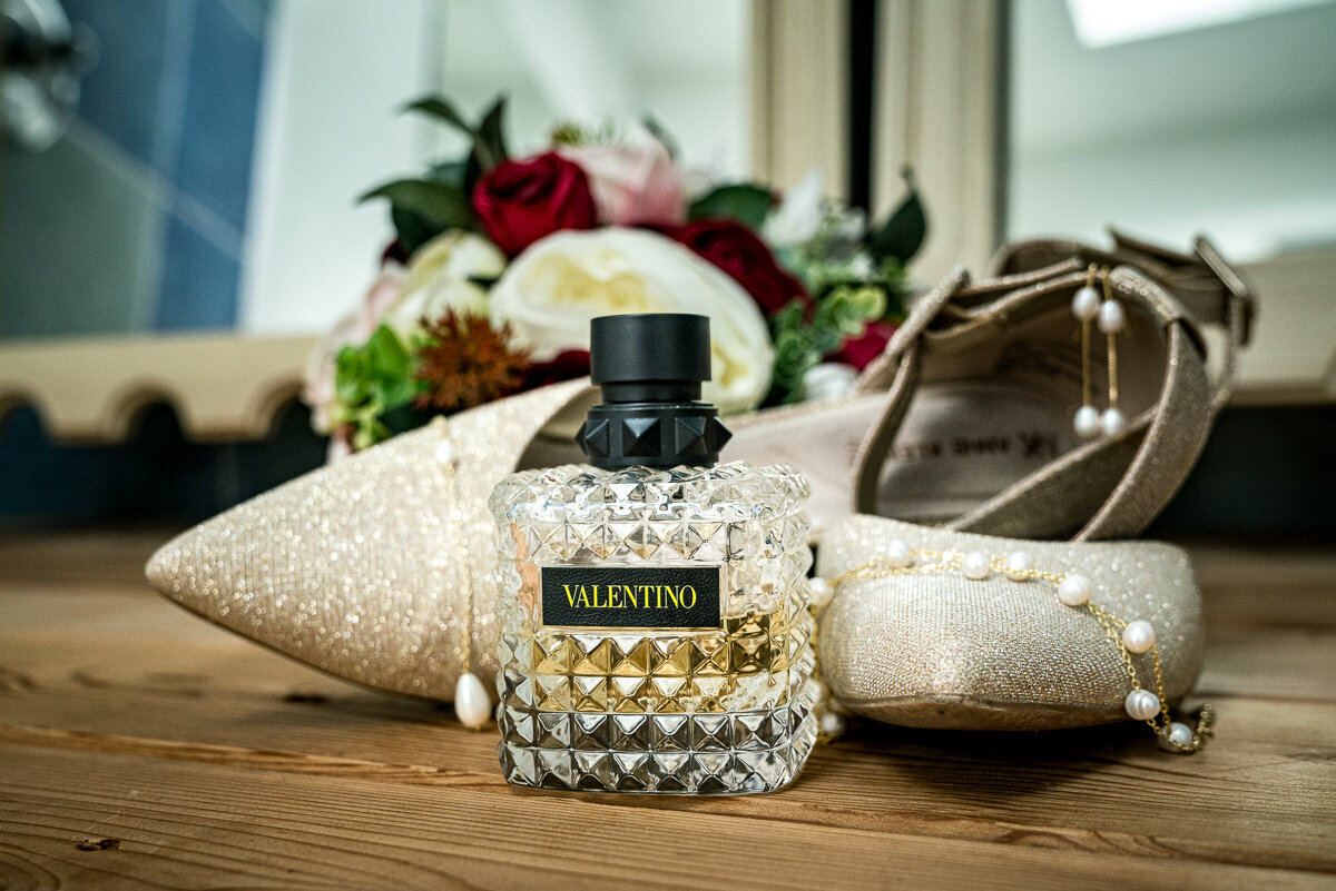 A beautifully styled flat lay of the bride's details at Mitchell Grove in Eureka. Featuring her elegant shoes, delicate jewelry, and an invitation suite, this image captures the timeless charm and attention to detail of her special day in the heart of Humboldt County.