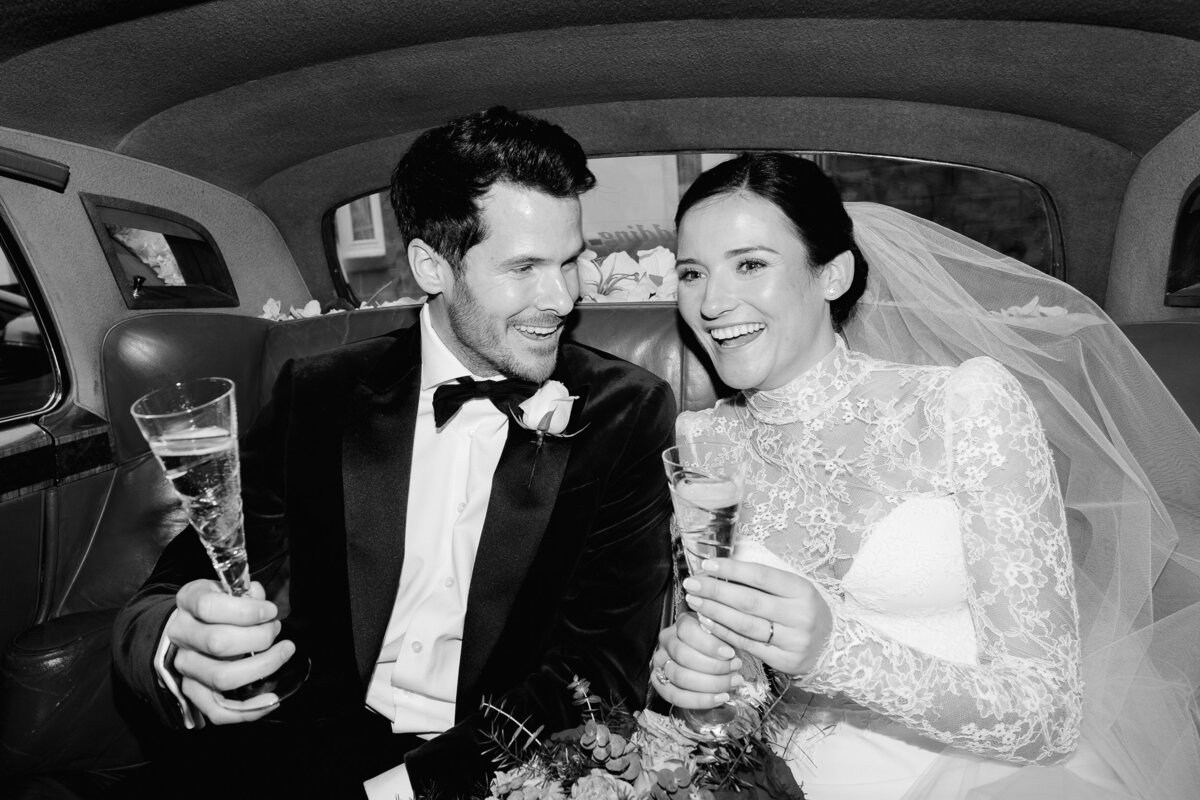 bride and groom laughing in the wedding car at their cheshire wedding