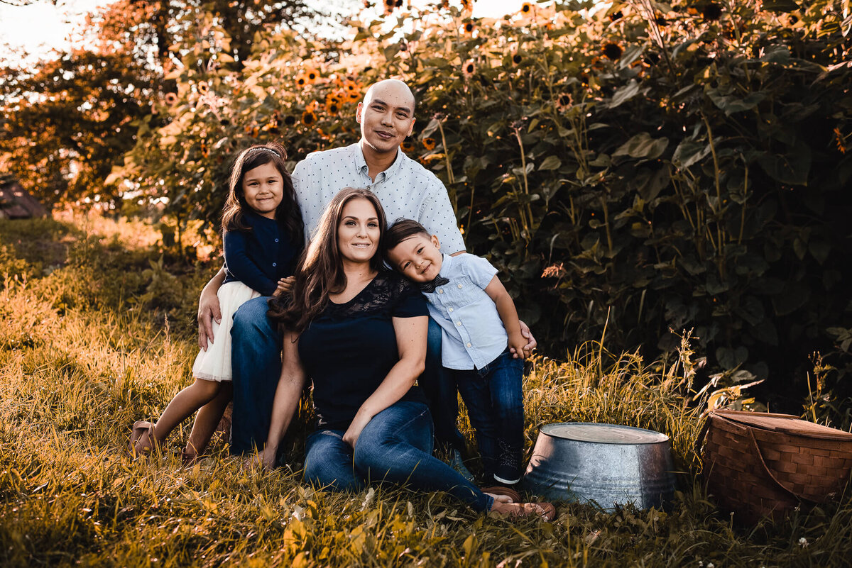Sweet family posing for Toronto family photographer in apple orchard in fall