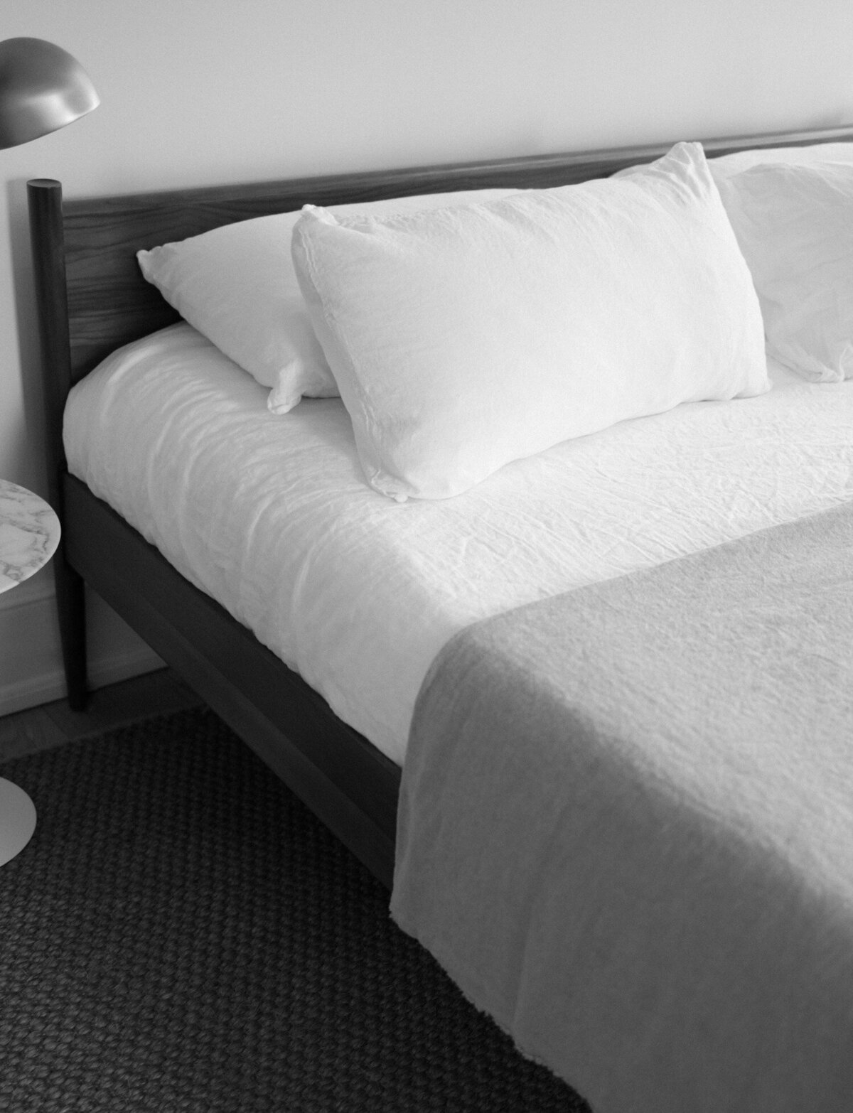 black and white texture of bed with linens, white sheets, ALEO Detroit bed and breakfast