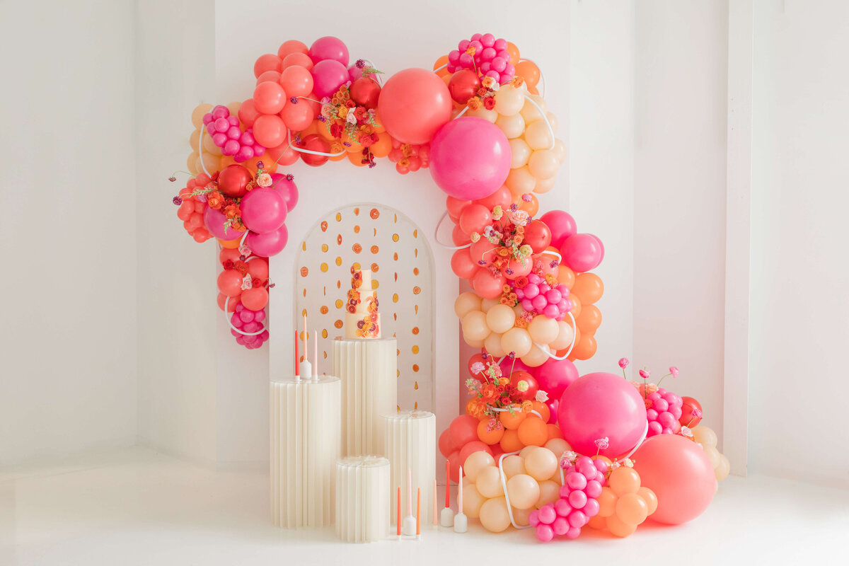Balloon arch with pink, orange and peach  balloons