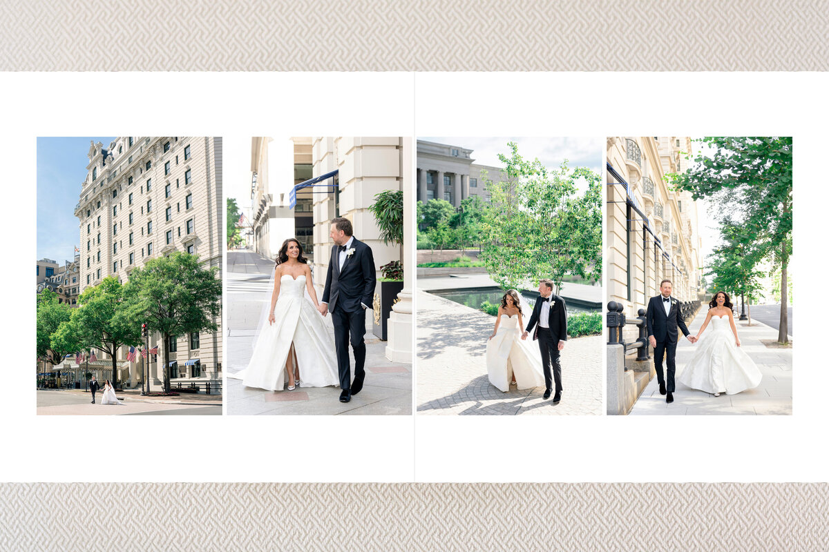 A couple in wedding attire walks through a cityscape. The bride wears a white gown, and the groom is in a black suit. They walk hand in hand, surrounded by urban buildings and trees under a clear blue sky.
