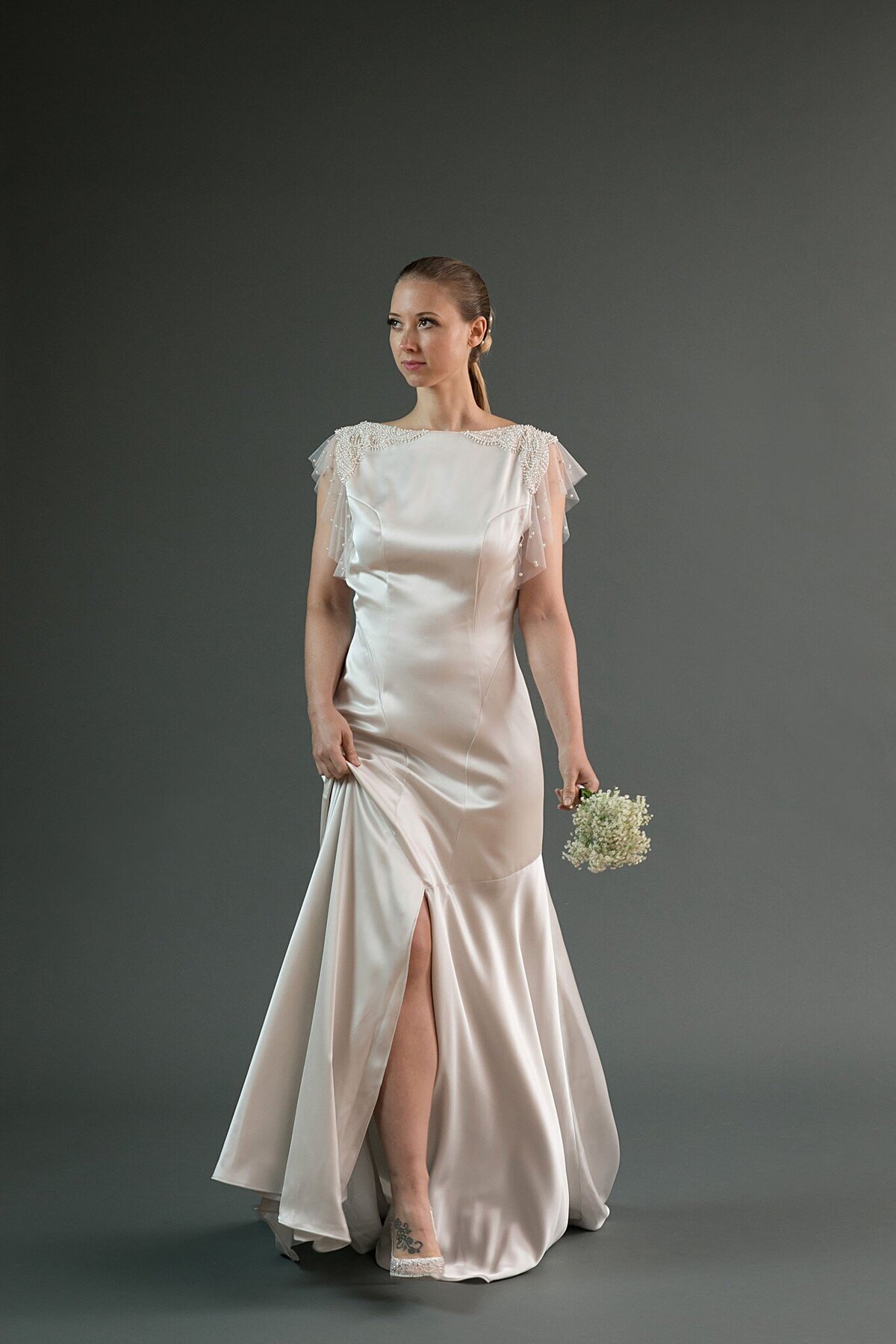 The Hana style is a slit-front, charmeuse wedding dress from Charleston bridal designer Edith Elan. It's shown in silver, but available in white.