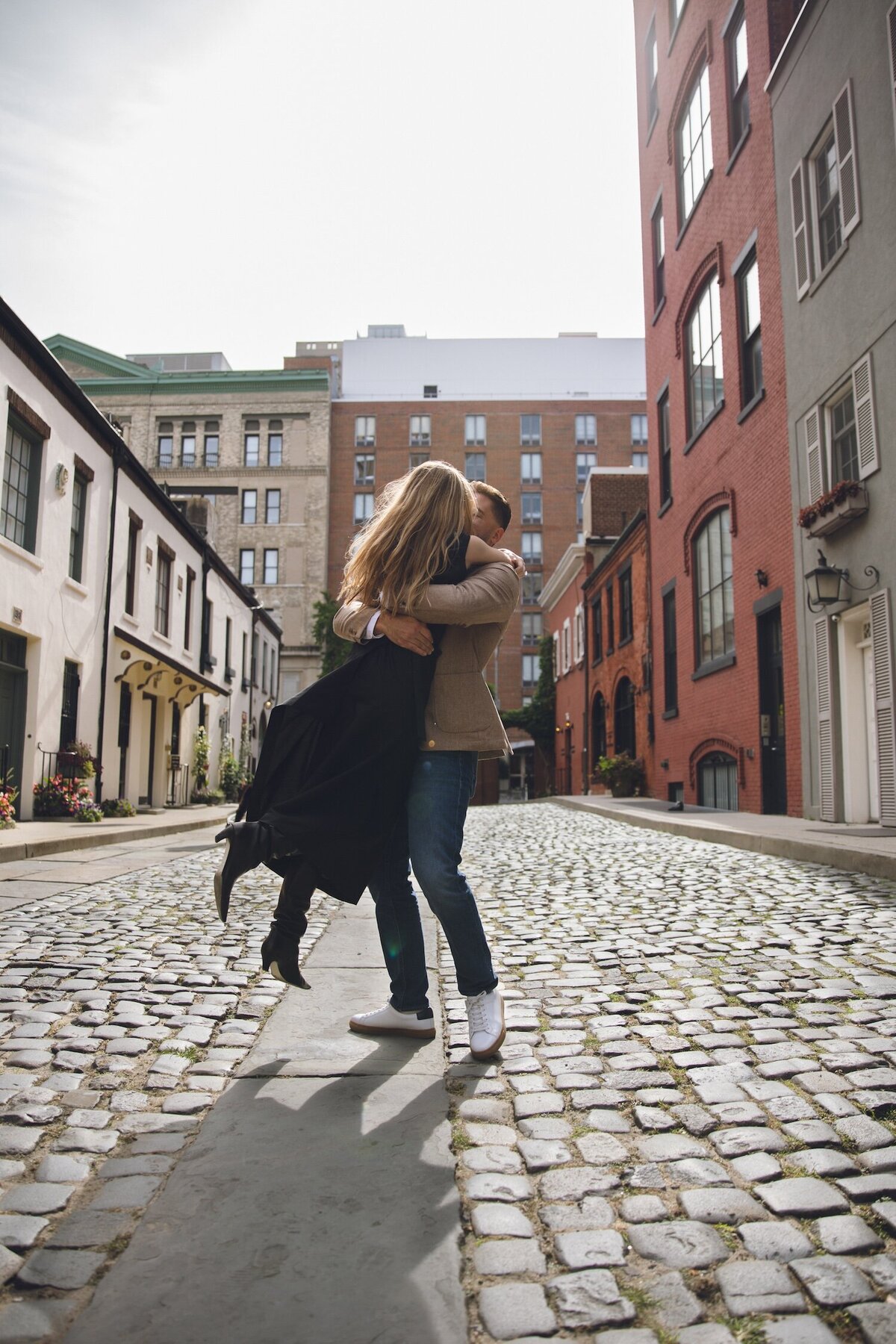 Newly engaged couple sharing a sweet embrace in Manhattan.