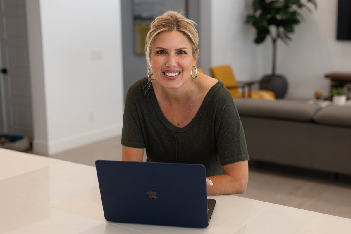 Accountant at home working on her laptop from the kitchen counter