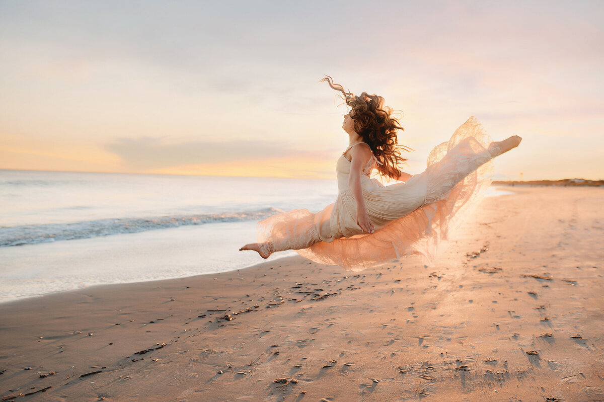 Girl dances on the beach during Family Photoshoot on Isle of Palms.