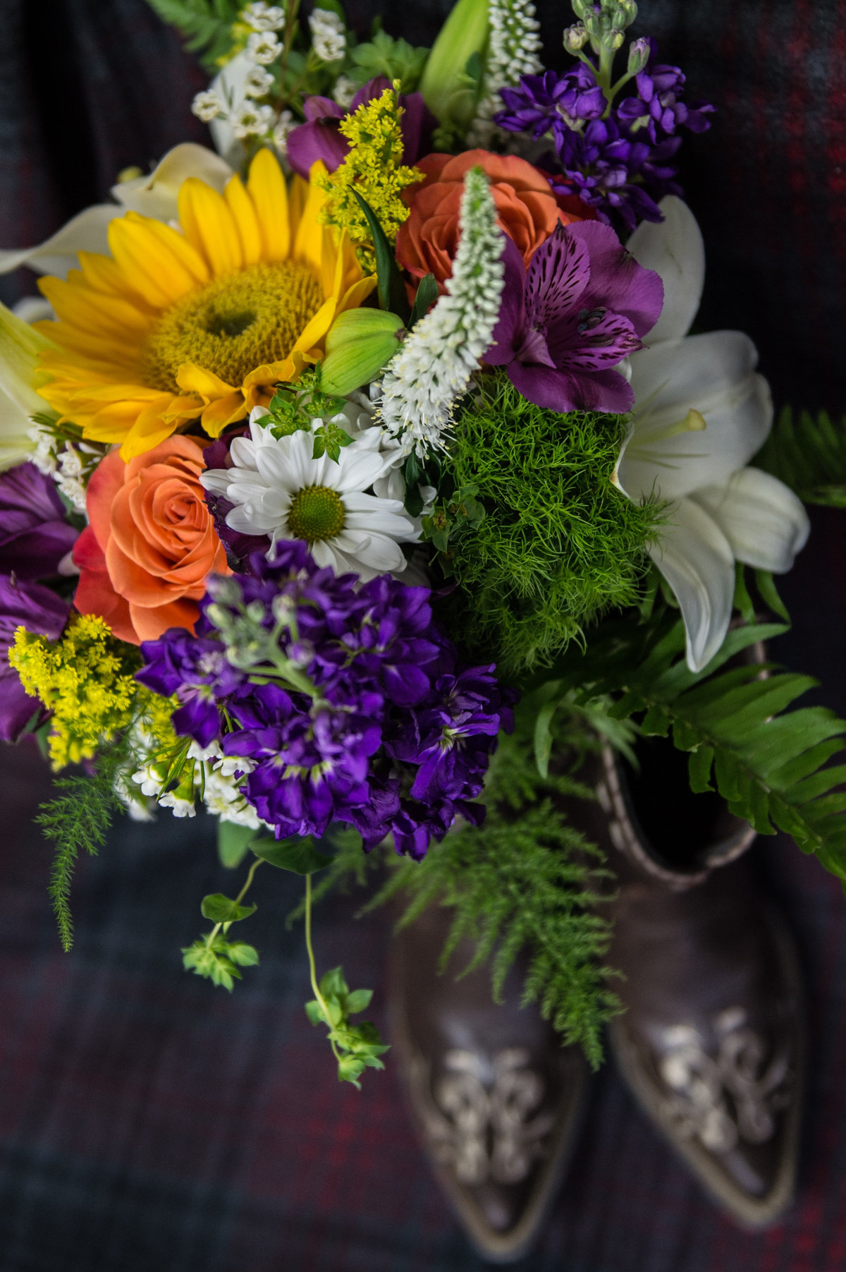 flowers with cowgirl boots in background