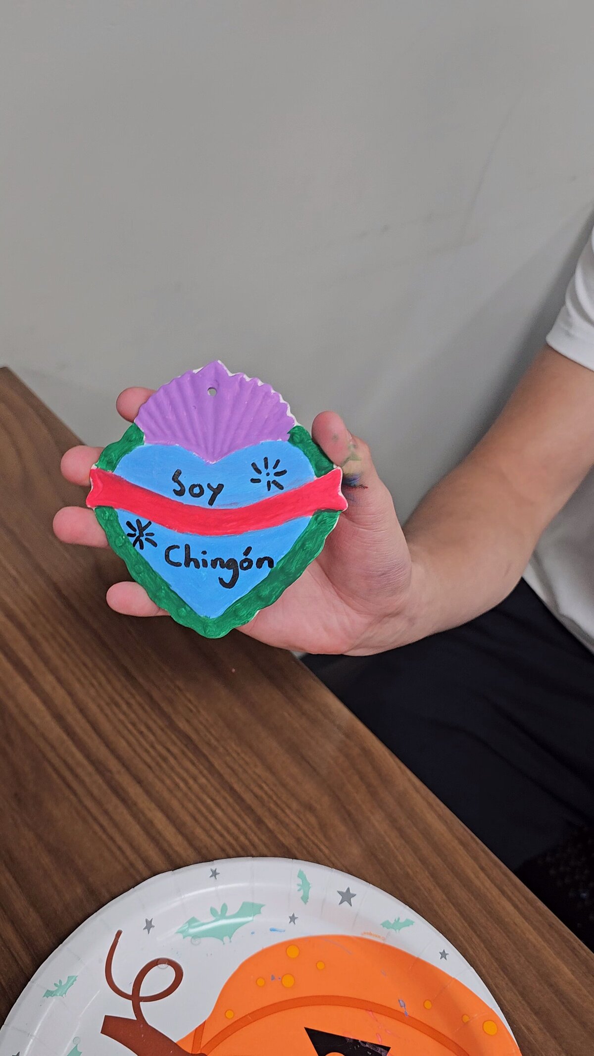 The artistic triumph as a workshop participant proudly presents their final masterpiece—a colorful heart adorned with an inspirational phrase. Tthe materials that brought this creation to life at Soleil Vida Studio.