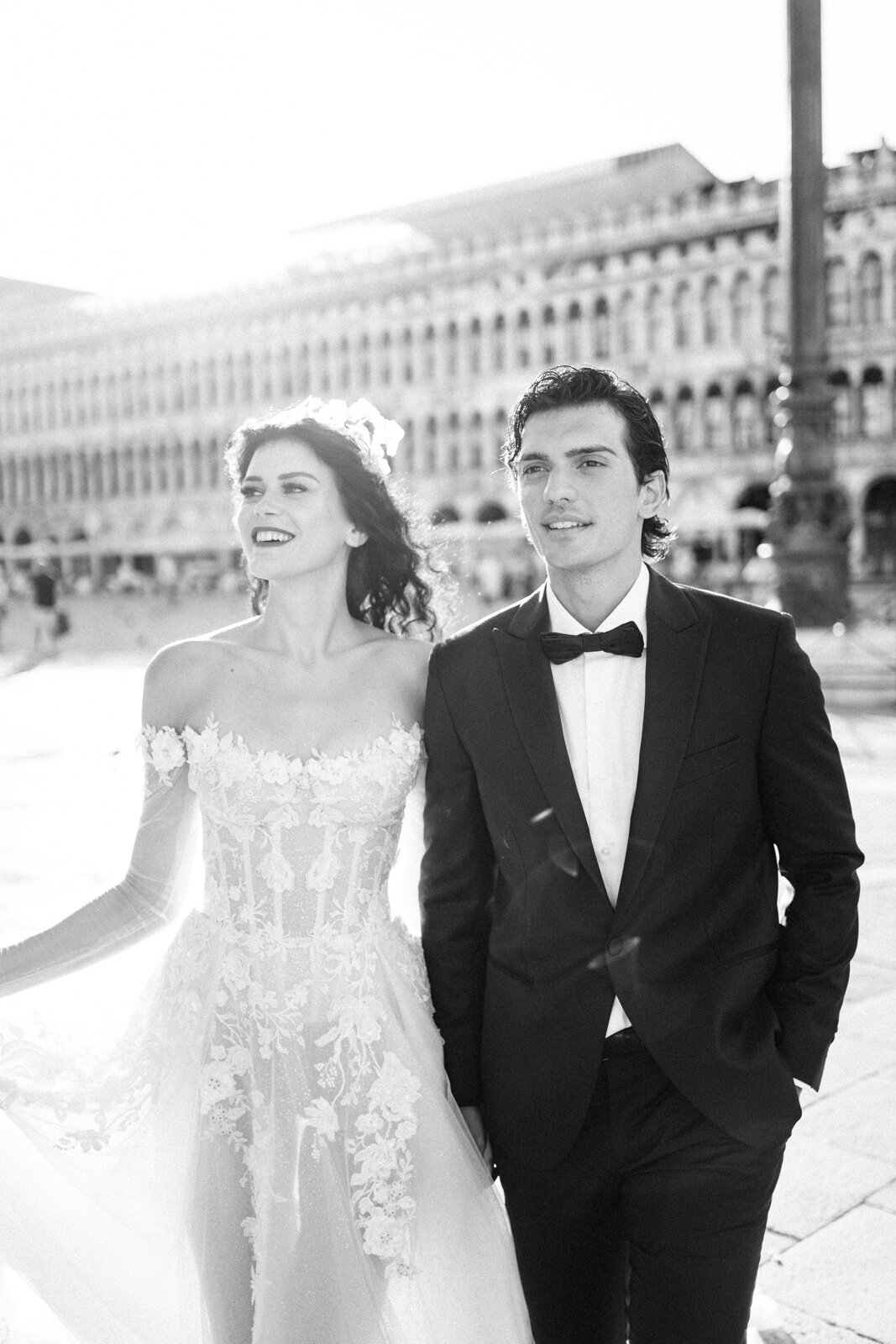 black and white portrait of a bride and groom in St Mark square in Venice