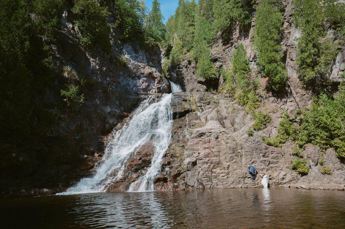 Waterfall and the couple climbing