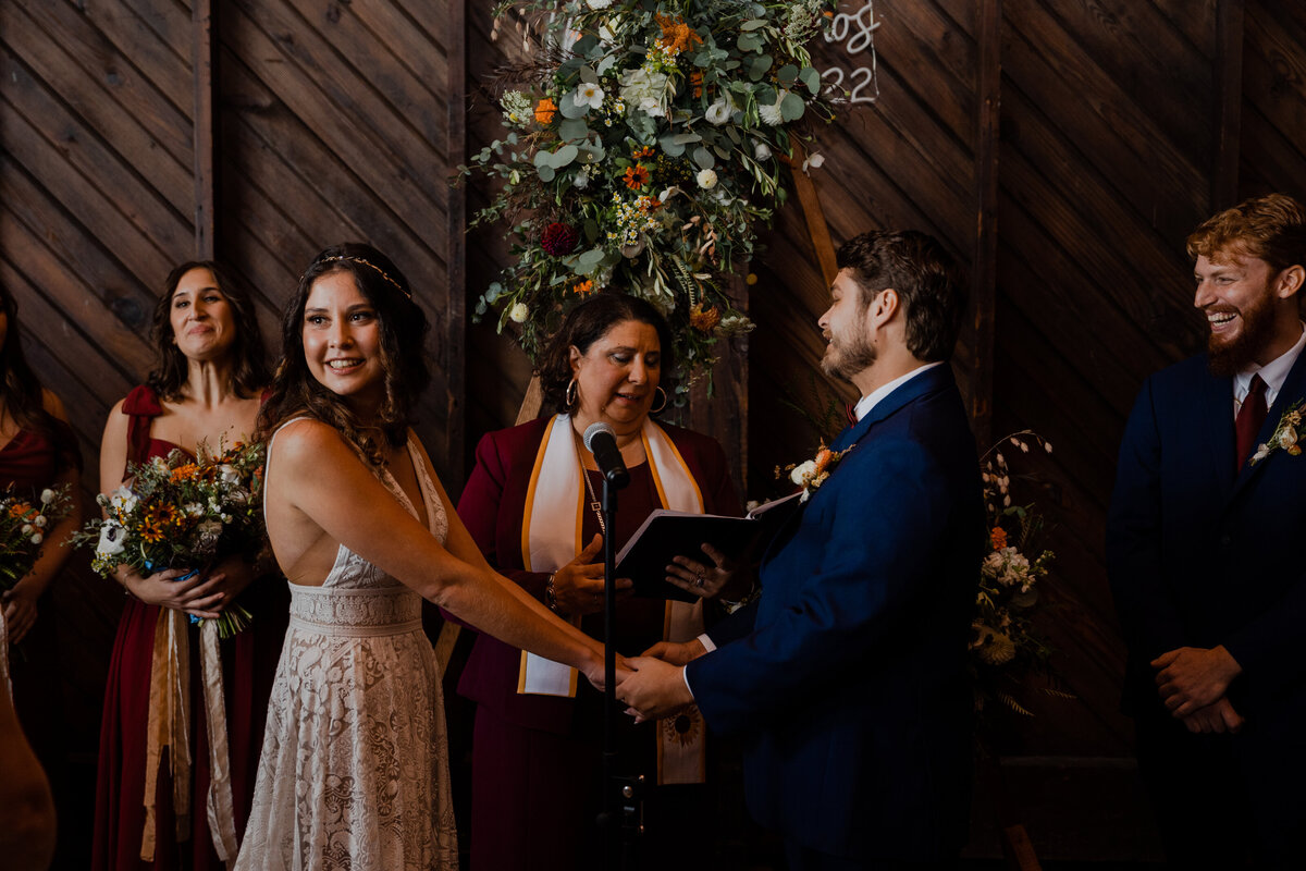 Bride and Groom holding hands during their wedding at Saltwater Farms Vineyard.