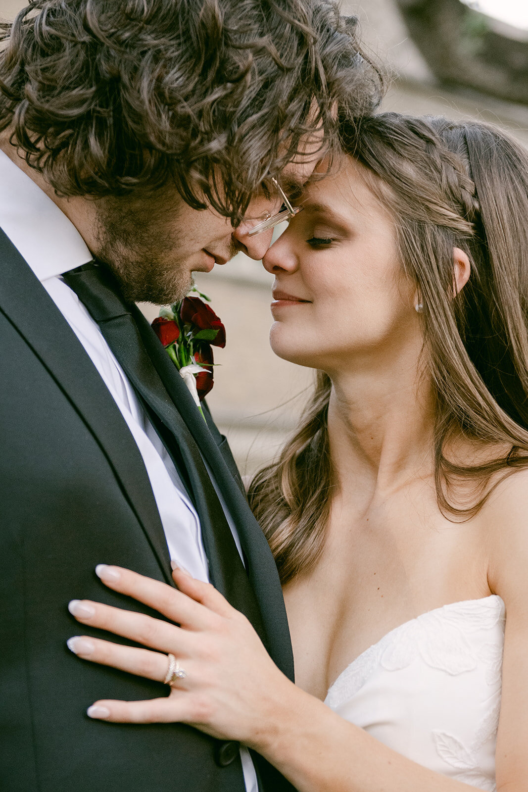 Soft moment of bride leaning on groom captured in romantic editorial wedding portrait in San Antonio