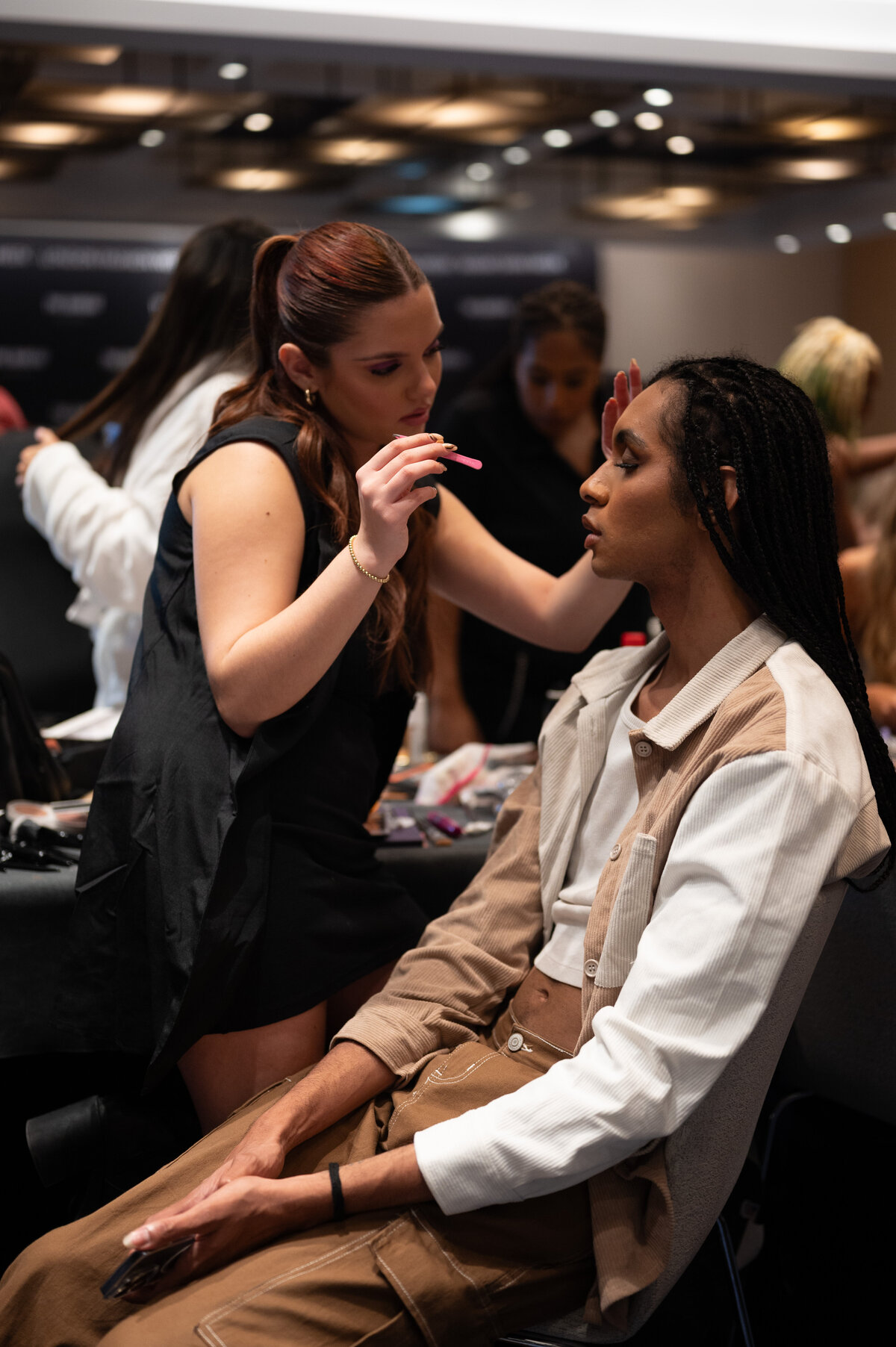 fashion model getting makeup done
