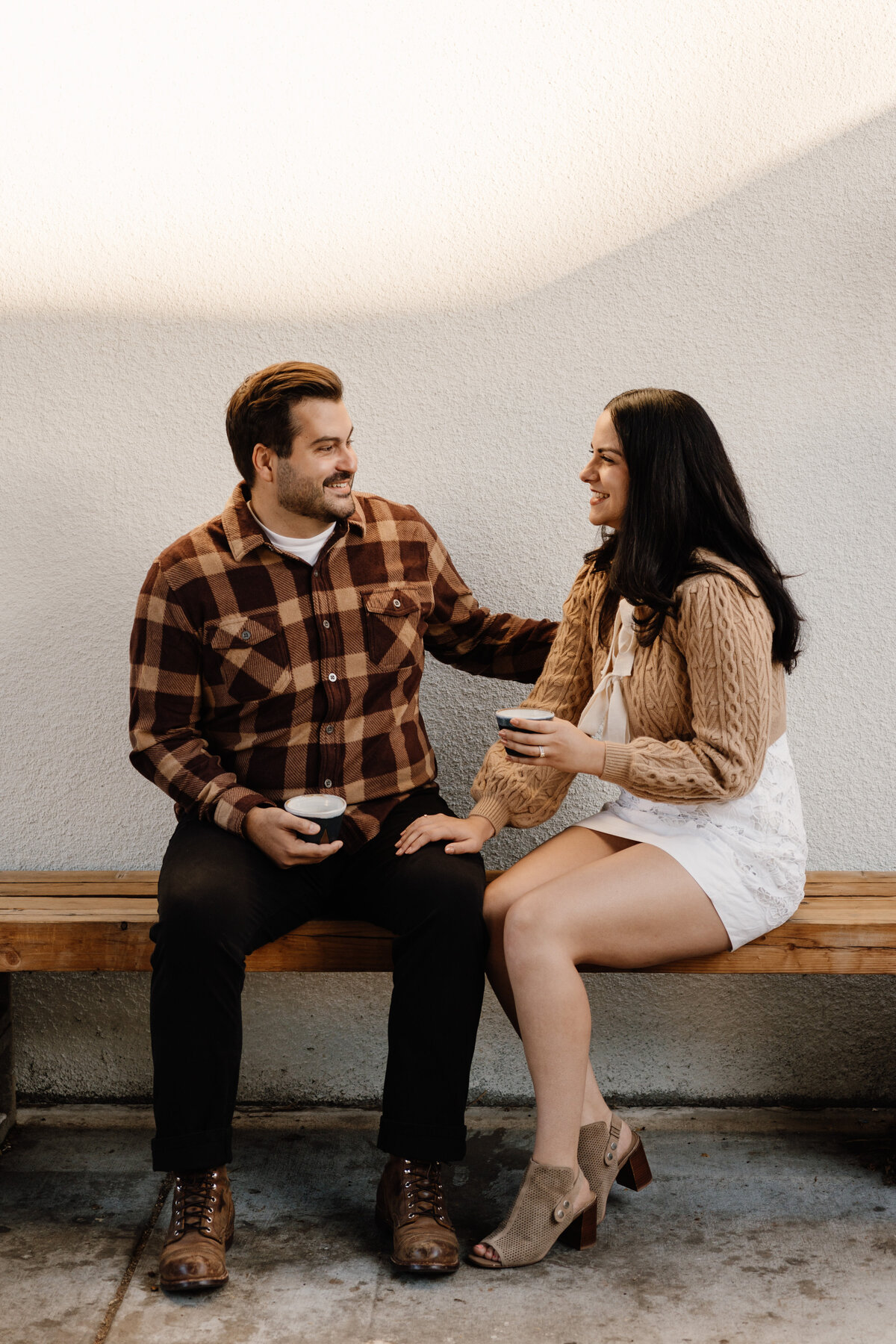 couple sits with coffee cups