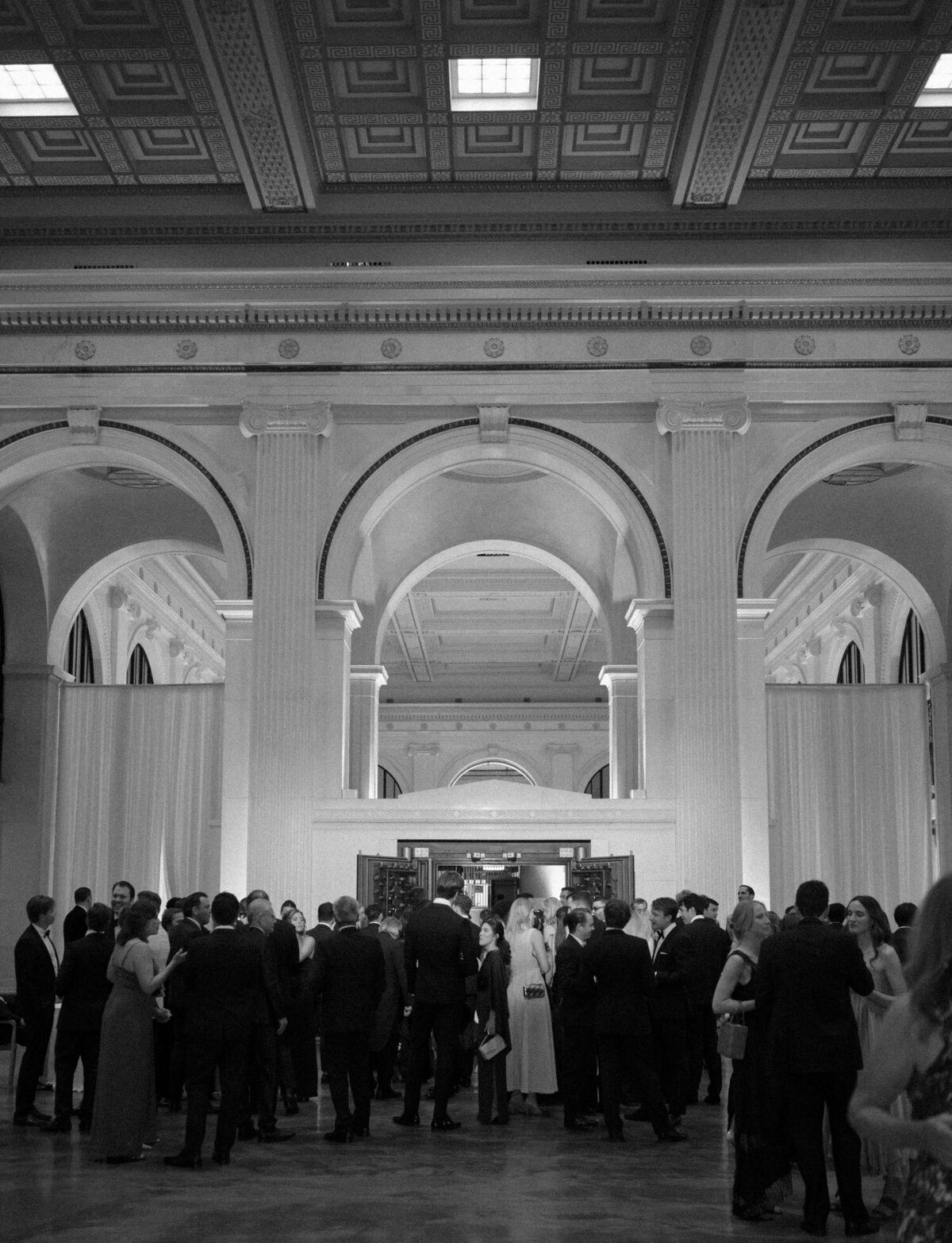 Guests enjoy cocktail hour amid stunning architecture at a wedding at State Savings Bank, Detroit