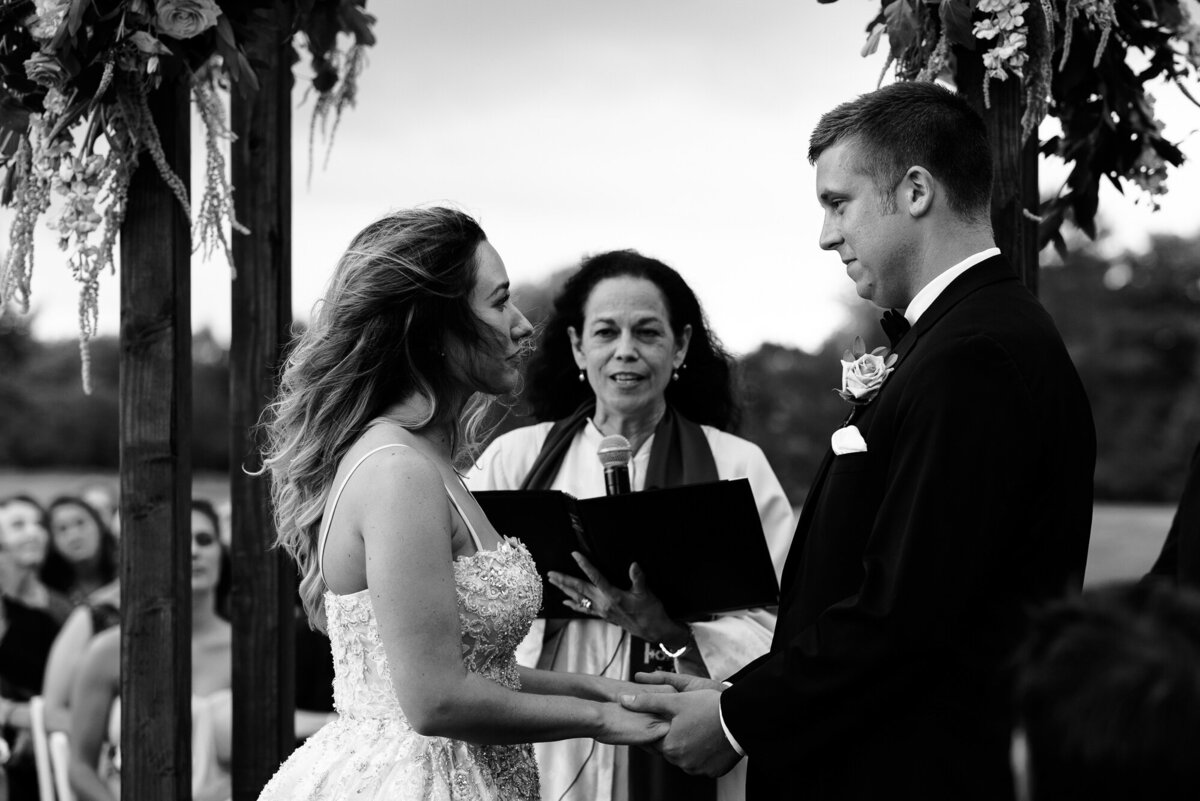 Bride and groom read their vows during their outdoor ceremony