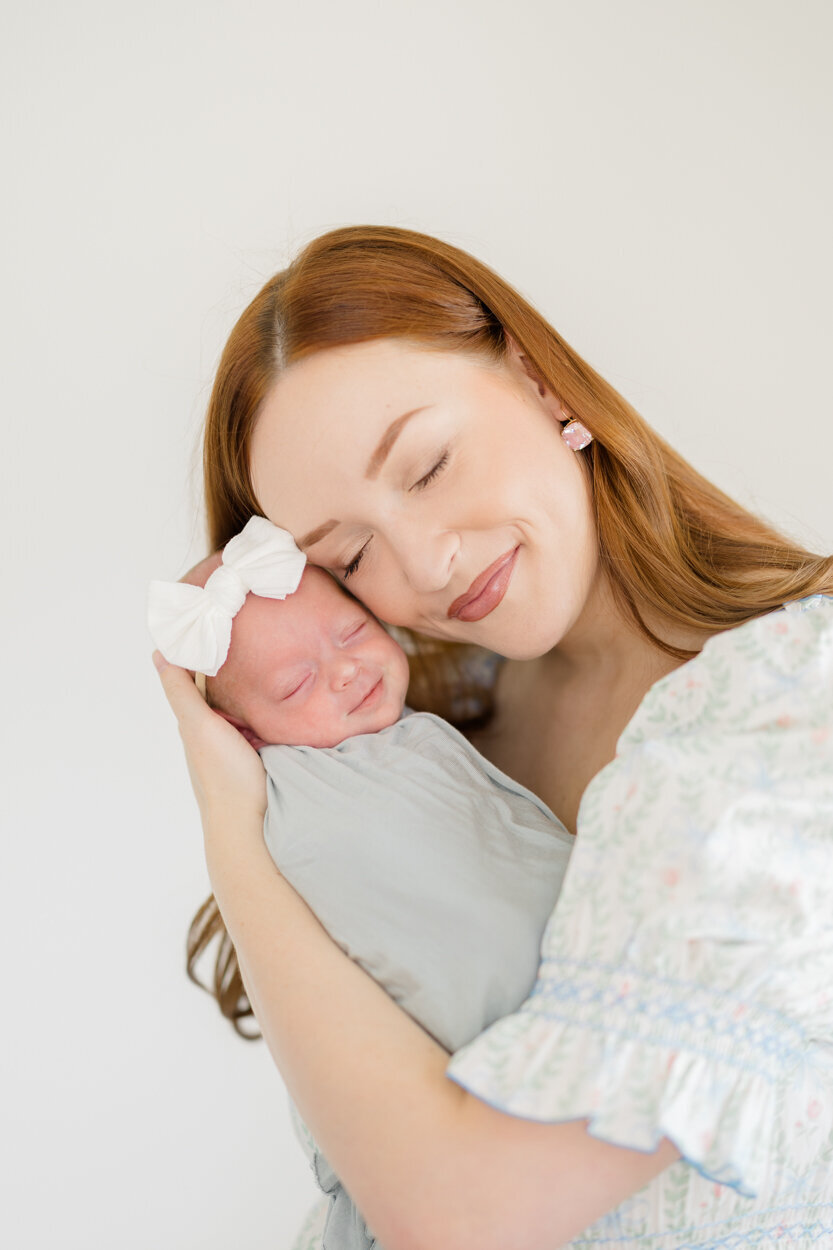 mama snuggling newborn