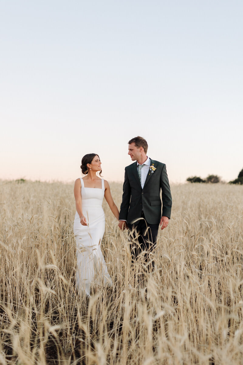Amelia and Scott having photos taken in grass field
