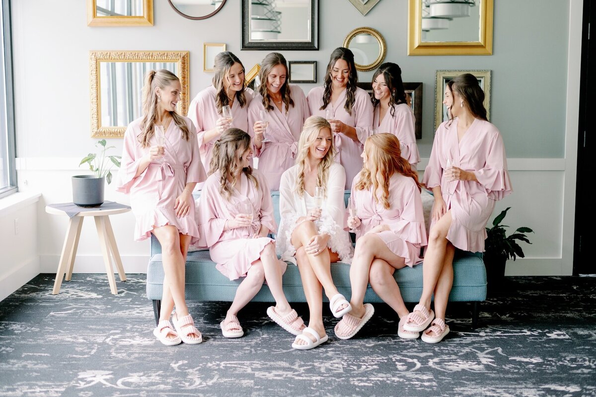 bride sitting with her bridesmaids on the morning of her wedding
