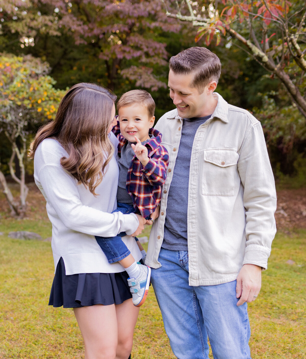 Mother and father holding their toddler during a family lifestyle session in Northern New Jersey