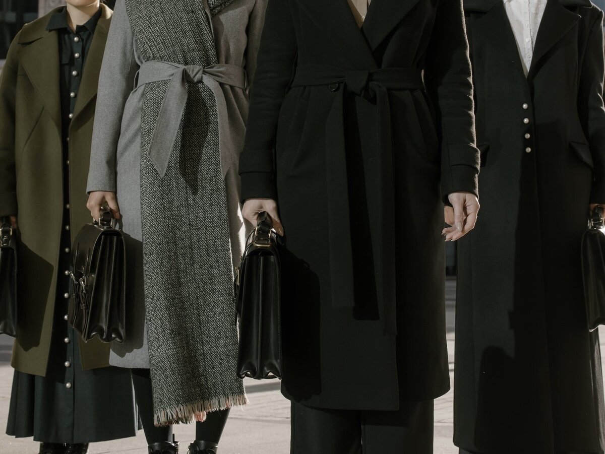 A lineup of professionals, each holding a black briefcase