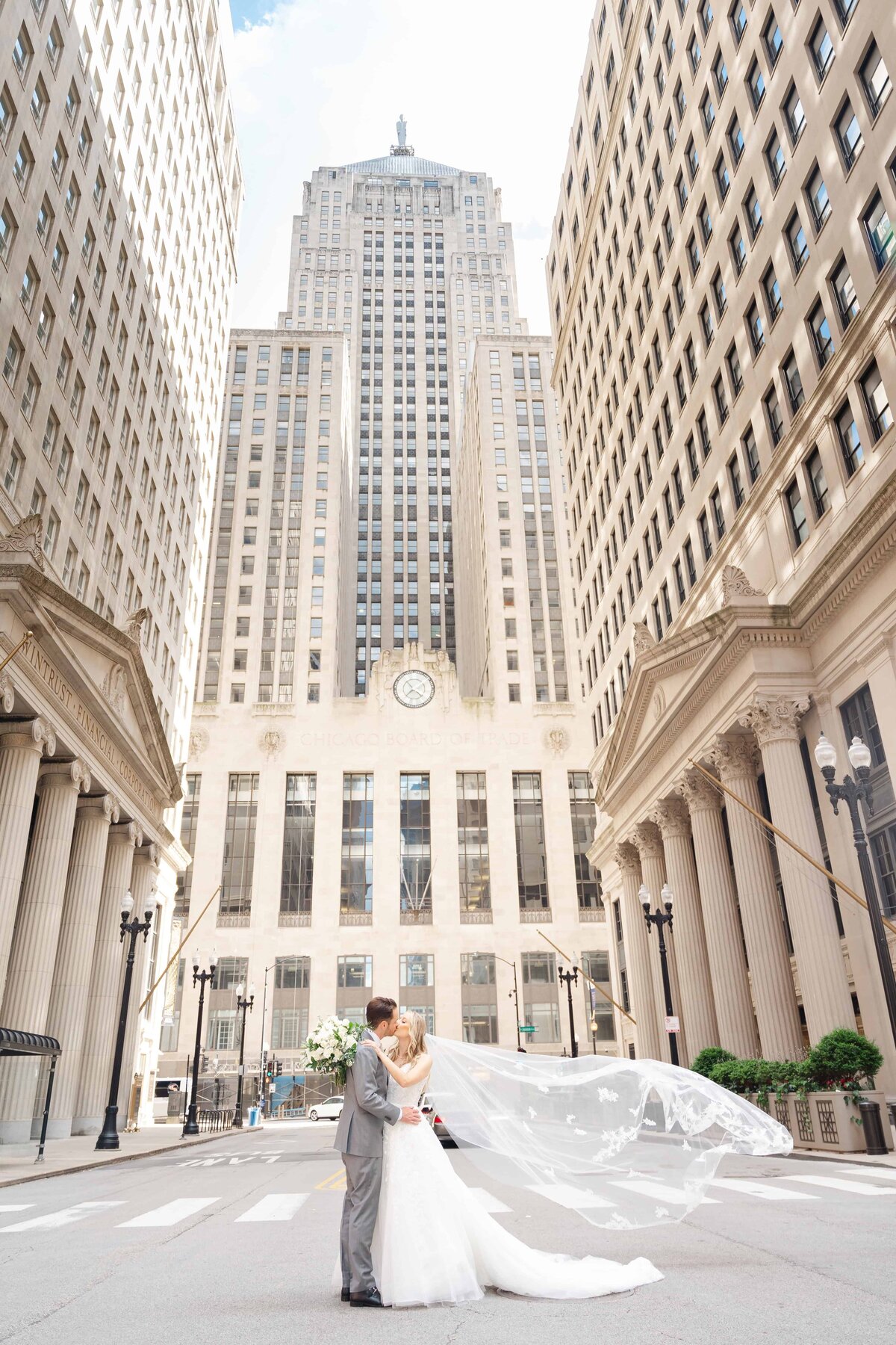 Board of Trade in Chicago Wedding portrait of bride and groom sharing a kiss.