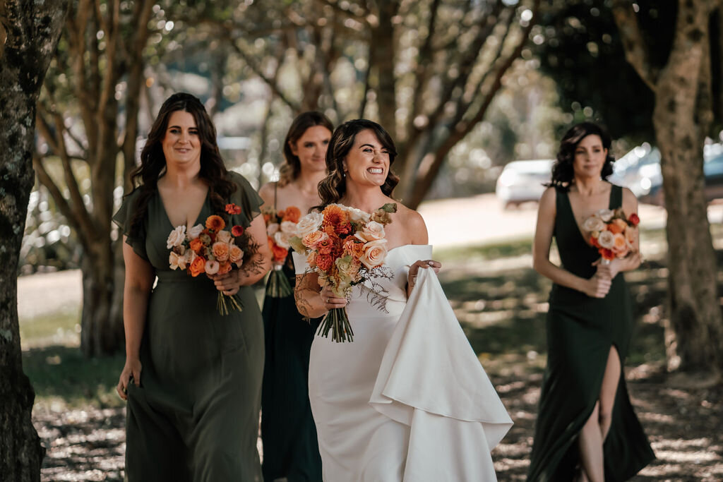 Bride and groom Lorna and Will celebrating their autumn wedding surrounded by guests and golden leaves, photographed by Zanthe Vorsatz Photography.