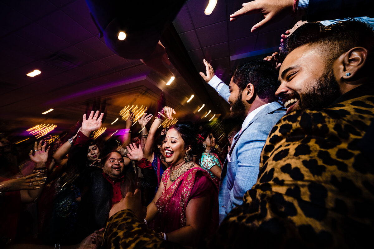 One of the top wedding photos of 2021. Taken by Adore Wedding Photography- Toledo, Ohio Wedding Photographers. This photo is of bride dancing at the wedding reception in Detroit Michigan