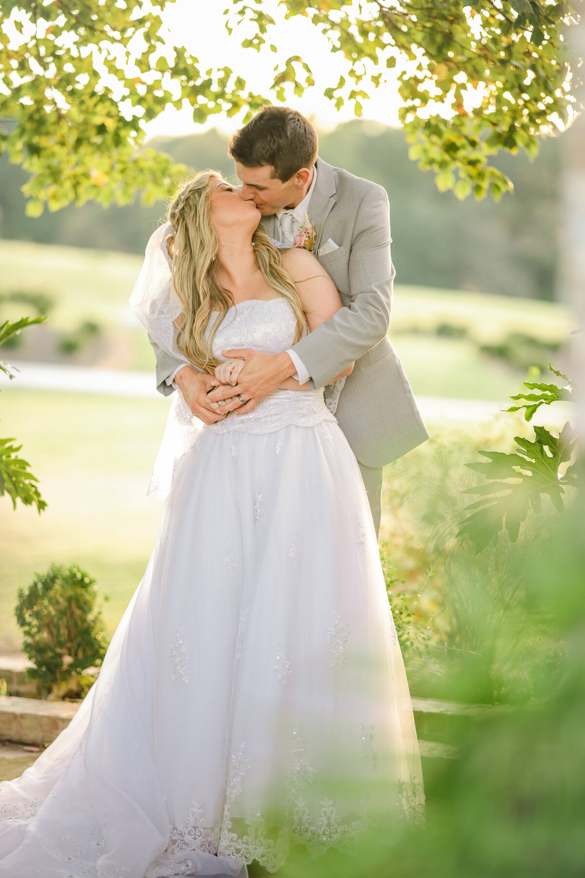 Bride & Groom share kiss beside greenhouse at West Milford Farm, Cumming, GA