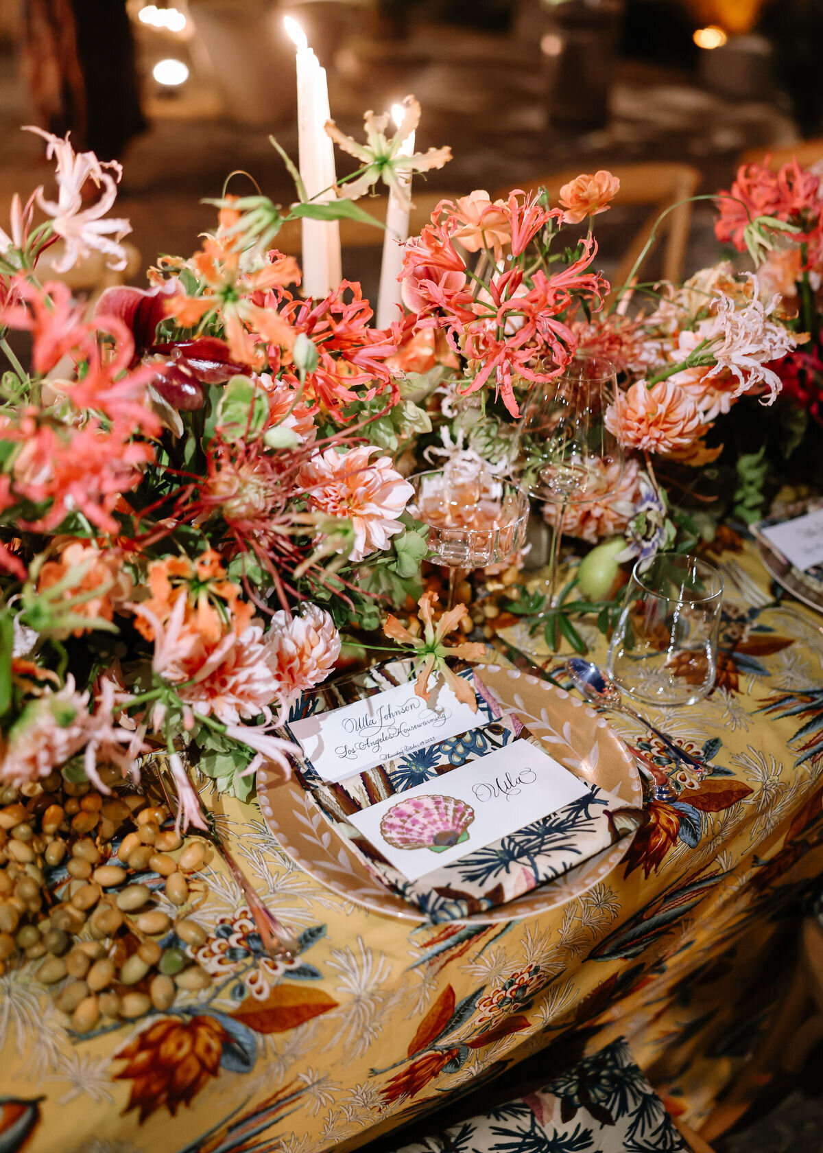 Moody editorial tablescape with coral flowers and layered textures, styled as design inspiration for an Airlie Gardens wedding reception