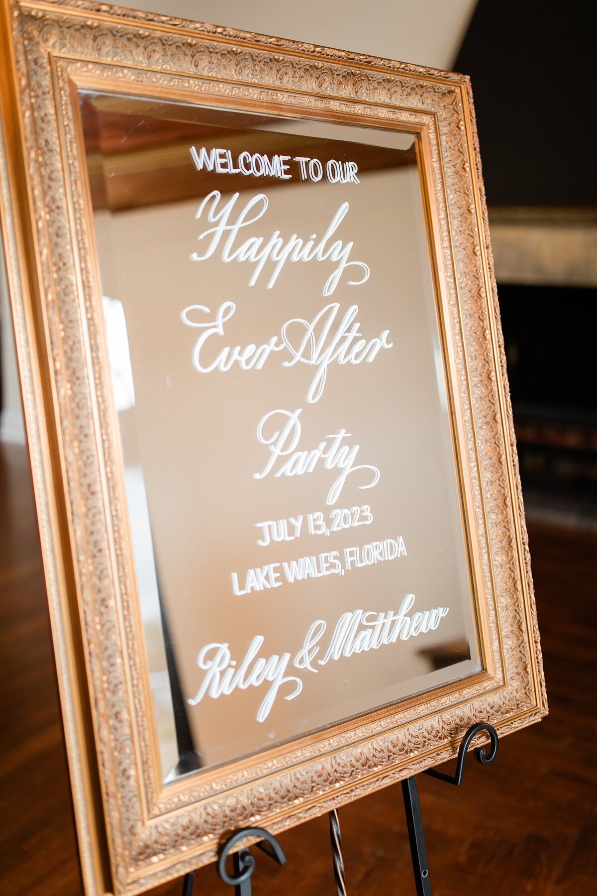Medium gold mirror with ornate border with calligraphy for welcome sign