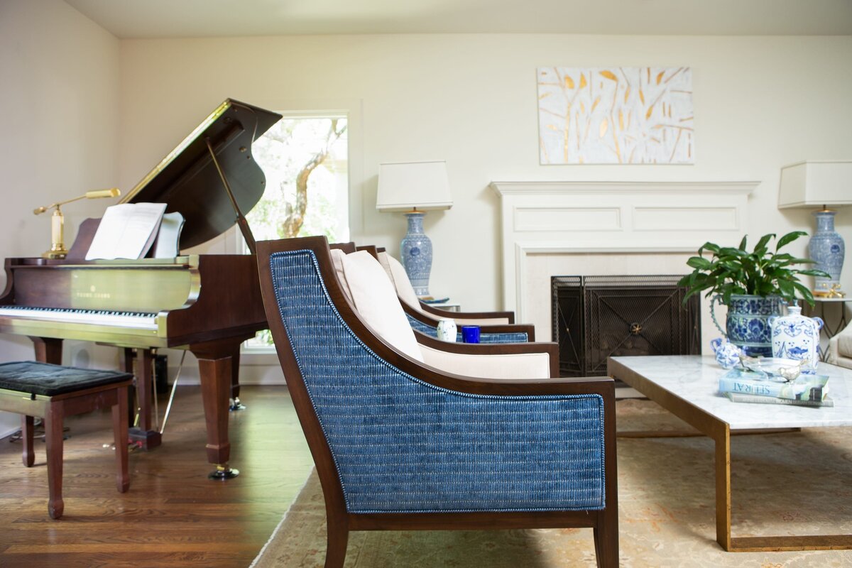 the keeping room interiors grant sitting area with blue chair and grand piano
