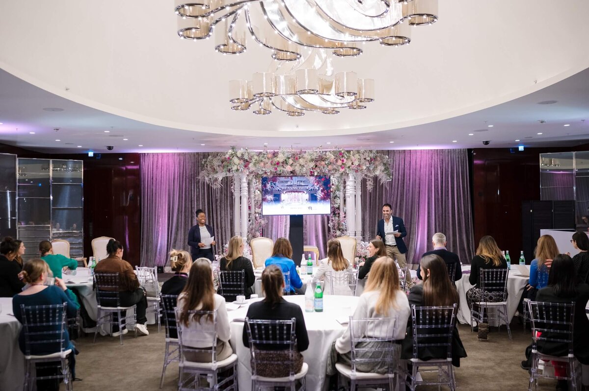 LaToya and Milan teaching a room full of attendees in the Bulgari London ballroom.