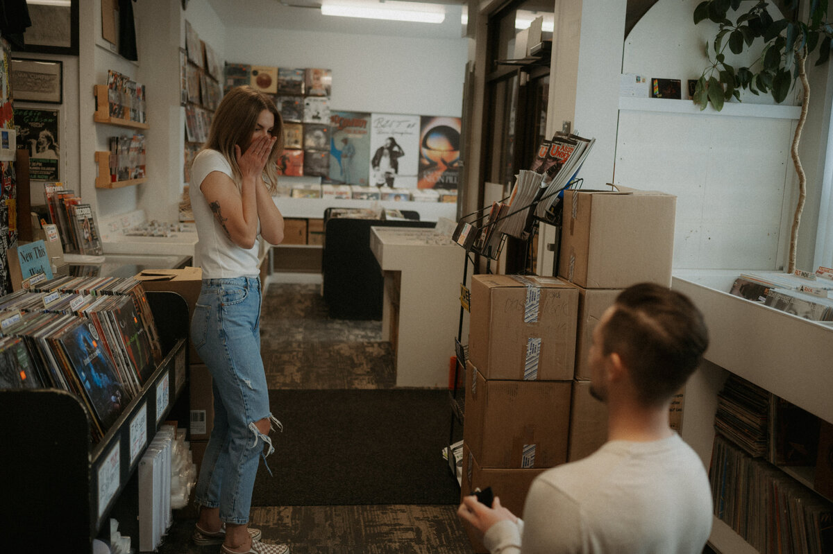 Couples proposal and engagement photoshoot taken at record store