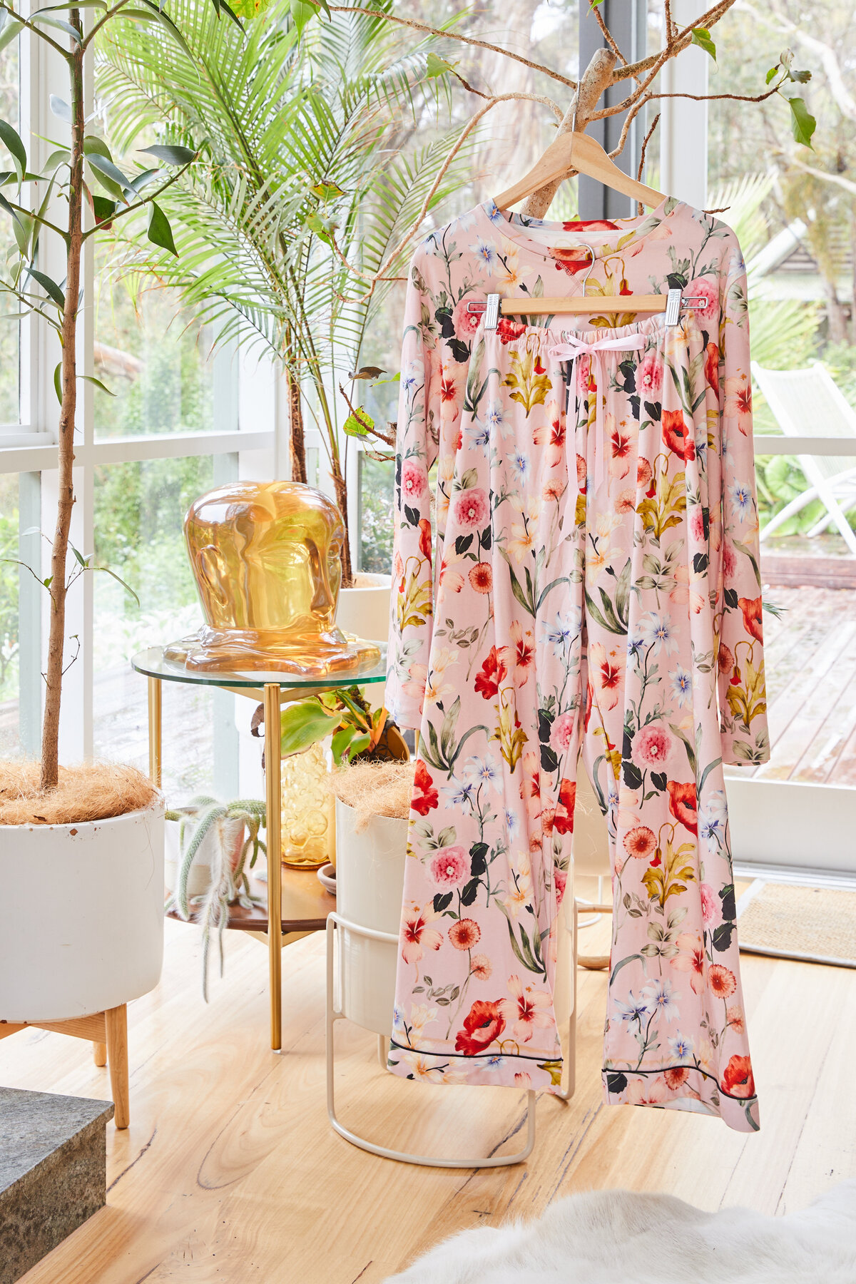 Pink floral pyjamas styled in modern Melbourne living room with greenery and natural light