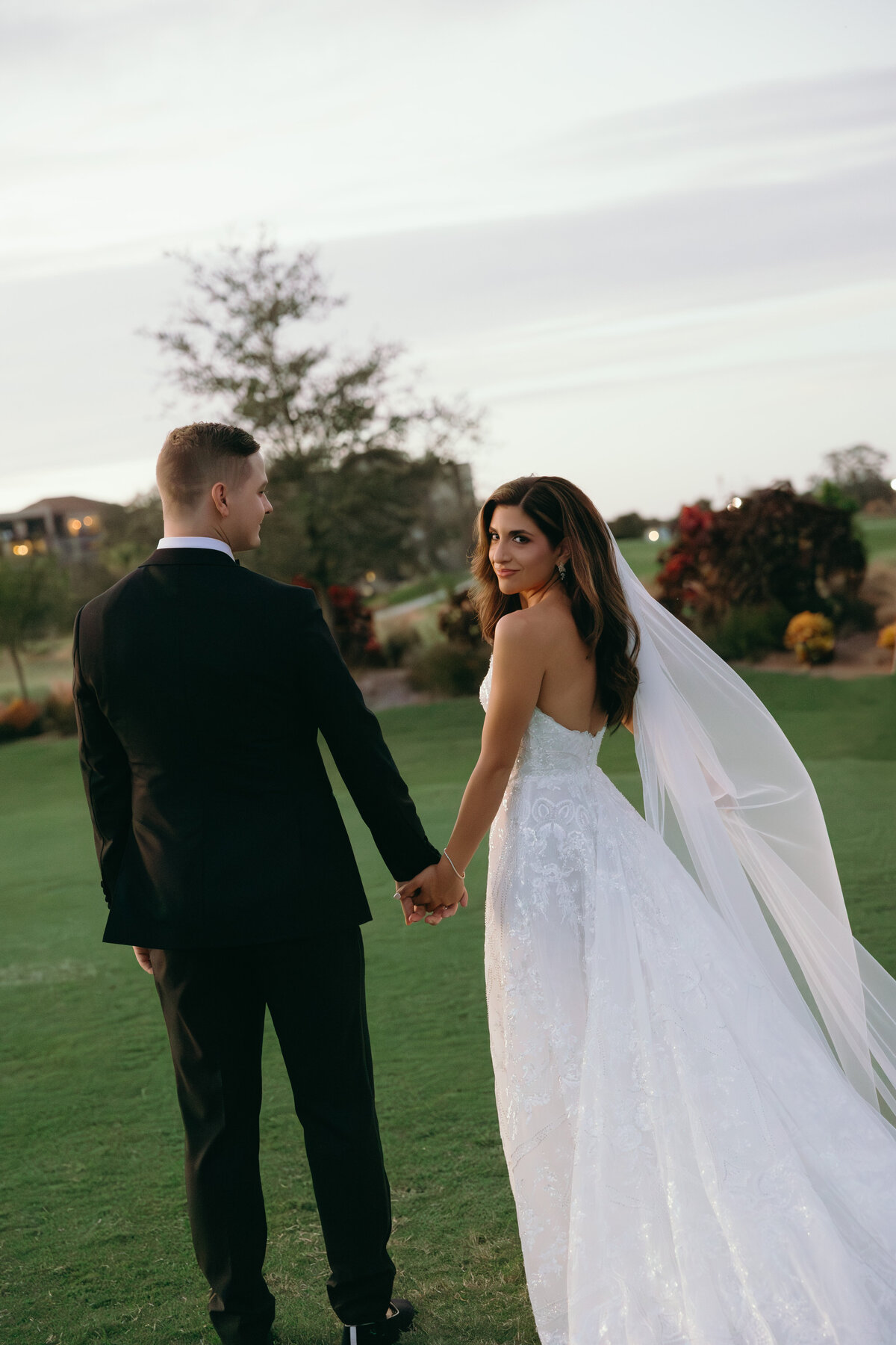 Bride and groom walking together and posing during their wedding in Naples Florida. 