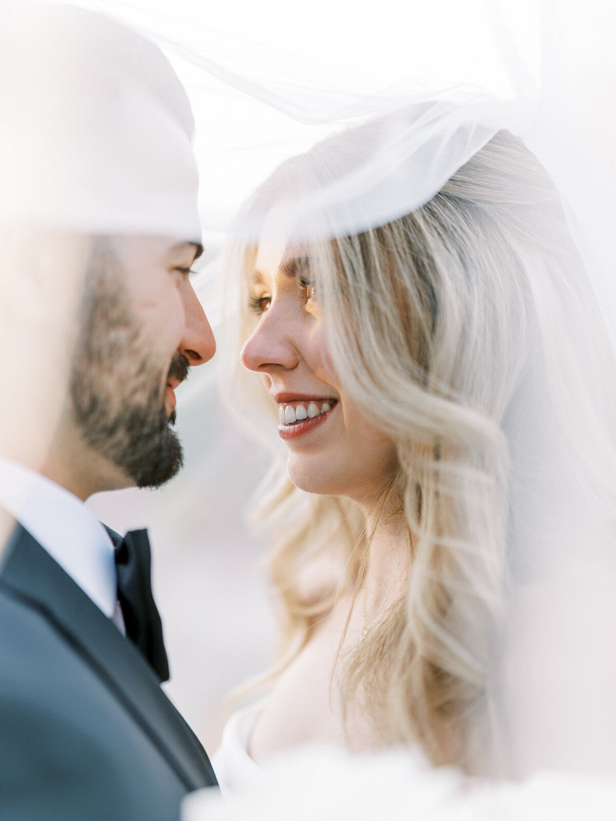 The bride and groom looking lovingly at each other during their photoshoot captured by Leana Myra Photography 
