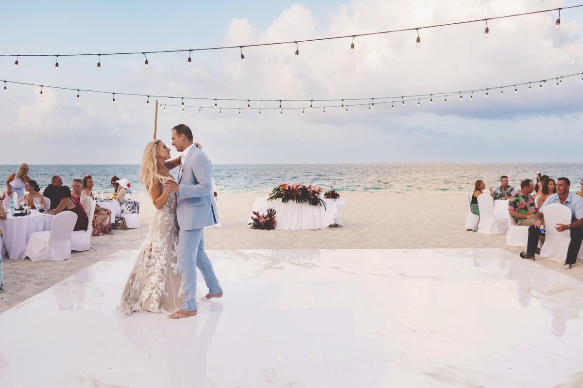 Bride and grooms dance on the beach in Cancun