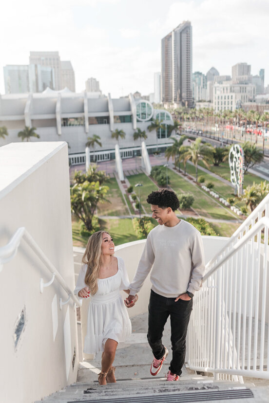 engaged-couple-walking-up-stairs-downtown-san-diego