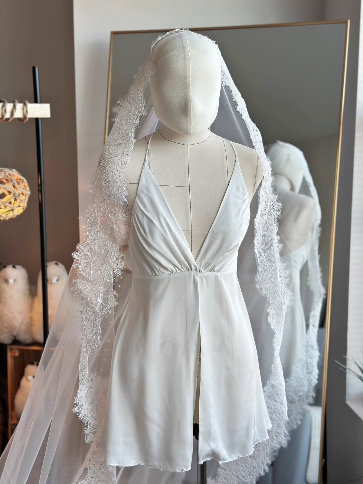 Handcrafted lace mantilla bridal veil draped over low bun hairstyle