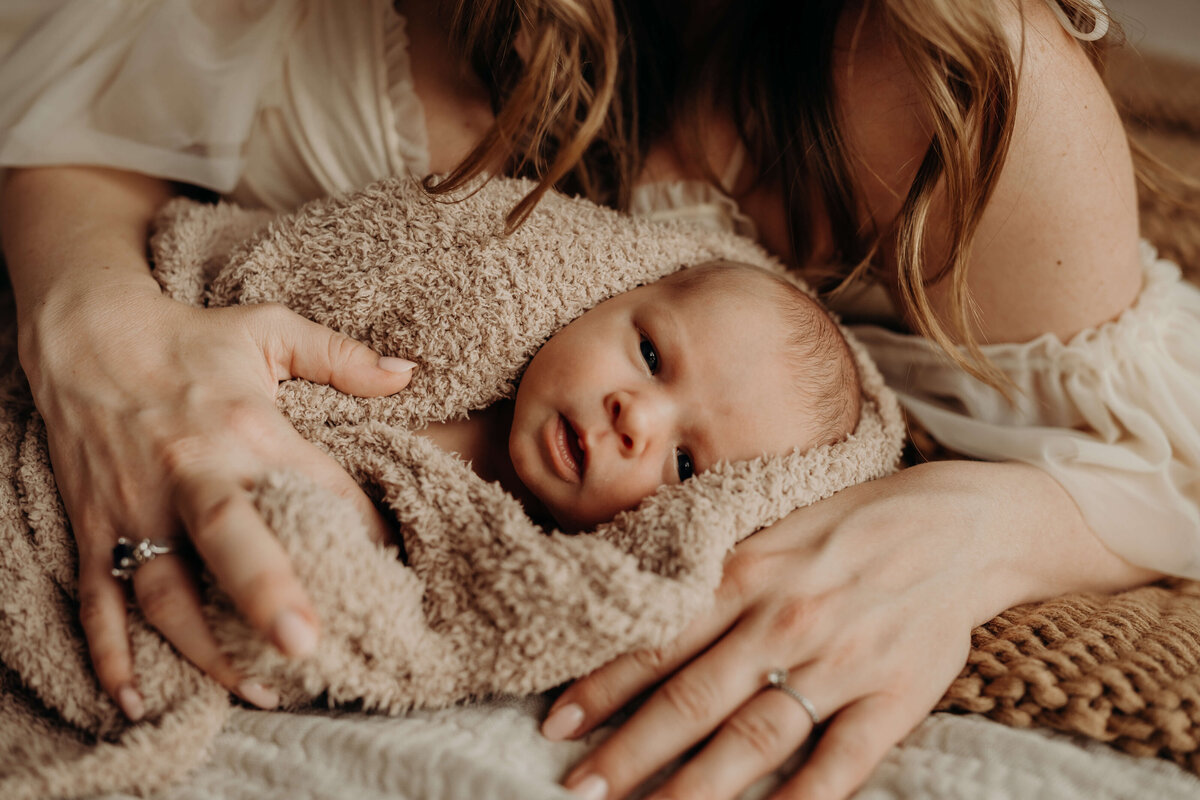 fine art newborn being held by newborn