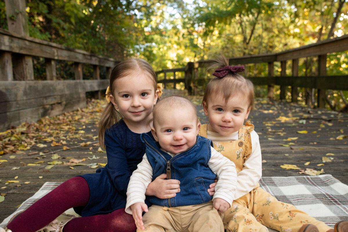 siblings smiling on boardwalk in Cuyahoga Falls