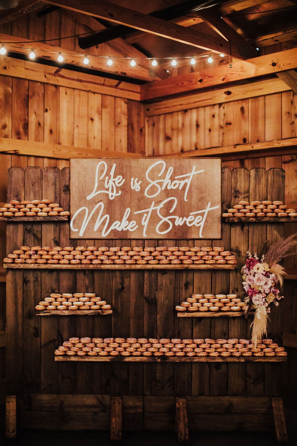 Life is Short Make it Sweet doughnut dessert wall at wedding