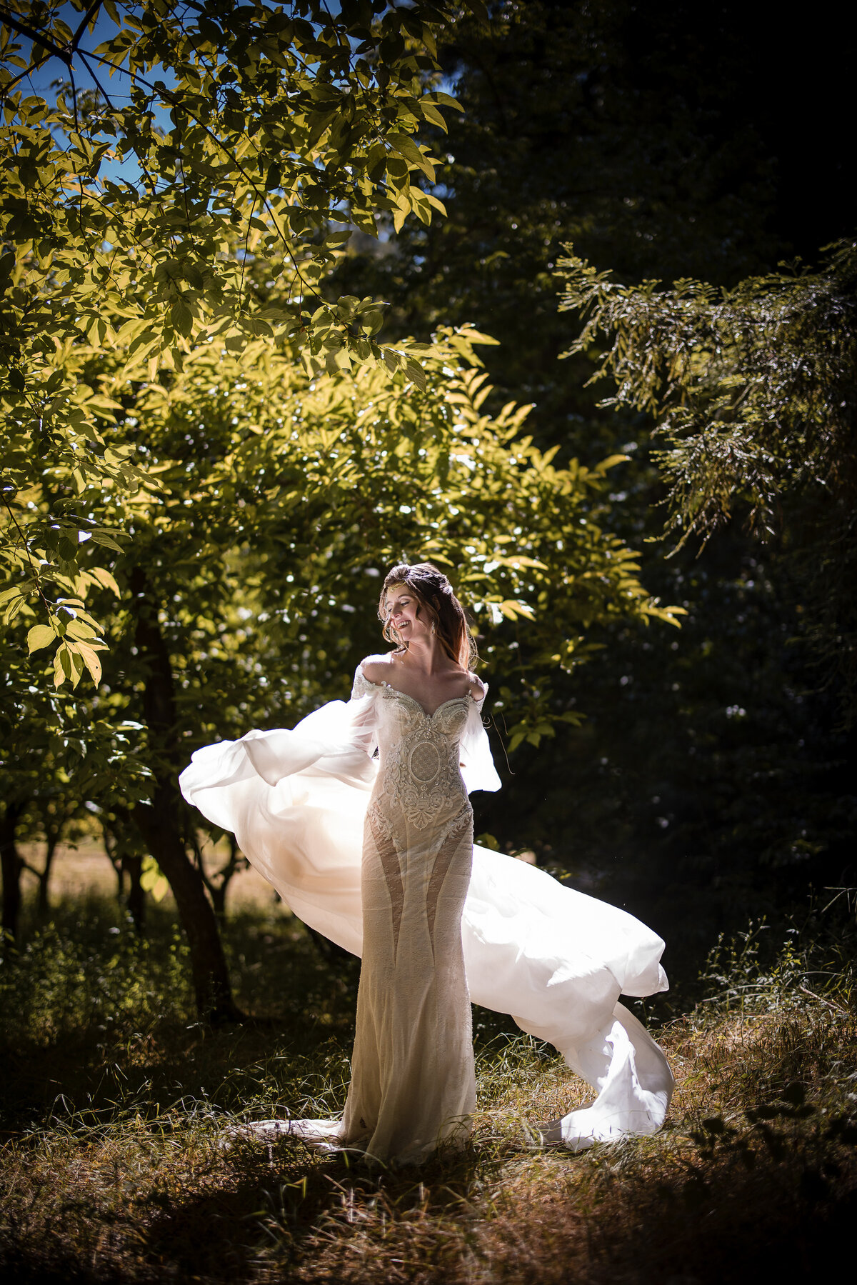 A bride poses in dramatic sunlight at a destination wedding at Nestldown in Los Gatos, California